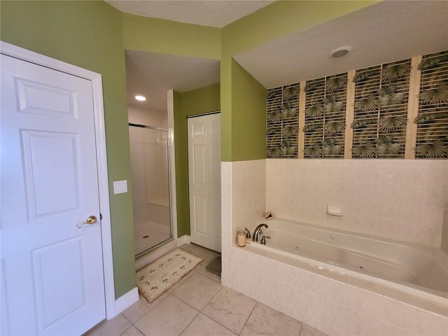 bathroom with tile floors, a textured ceiling, and separate shower and tub