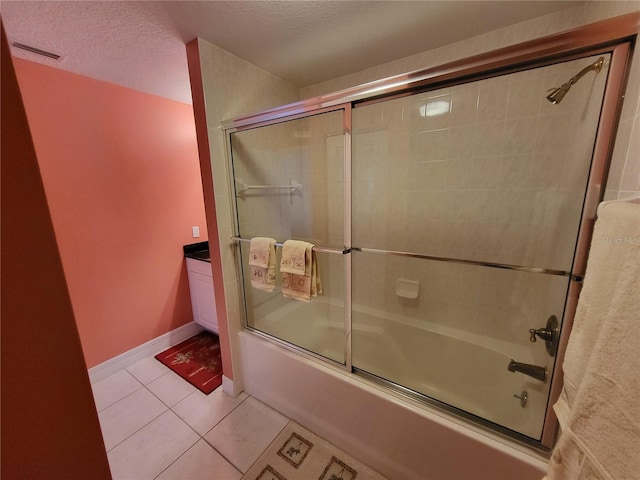 bathroom with enclosed tub / shower combo, tile flooring, and a textured ceiling