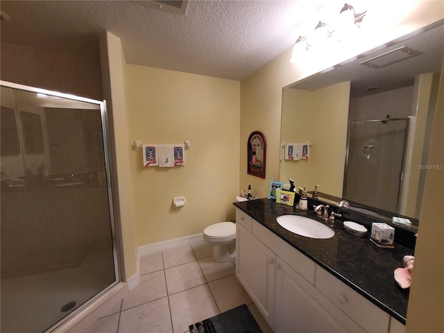 bathroom featuring toilet, an enclosed shower, tile flooring, a textured ceiling, and vanity