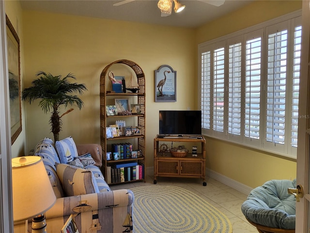 interior space with light tile floors and ceiling fan