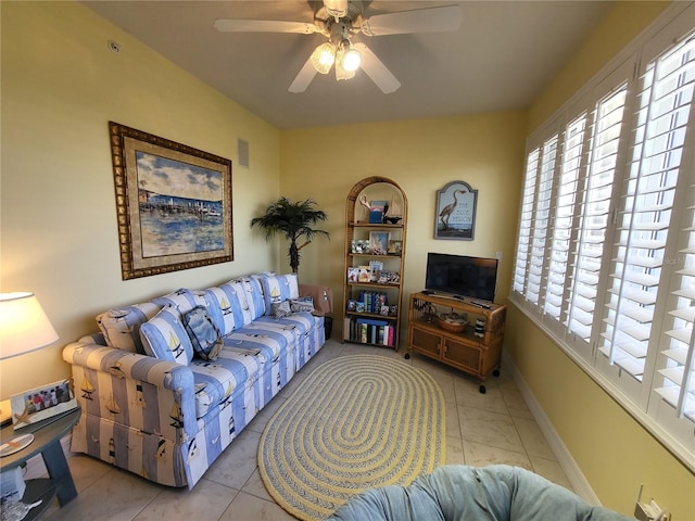 living room featuring light tile floors and ceiling fan