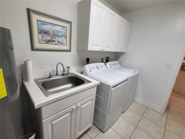 washroom featuring cabinets, separate washer and dryer, sink, and light tile floors