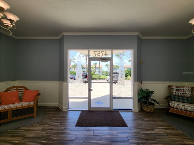 doorway to outside featuring a notable chandelier, french doors, and ornamental molding