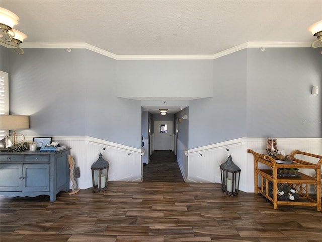 entryway featuring a textured ceiling, dark hardwood / wood-style floors, and ornamental molding