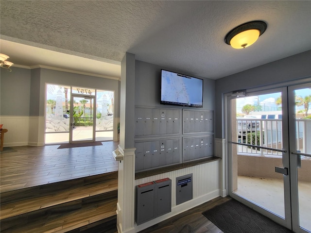 interior space featuring a mail area, a textured ceiling, and french doors