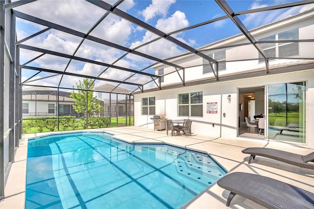 view of pool with a patio and a lanai