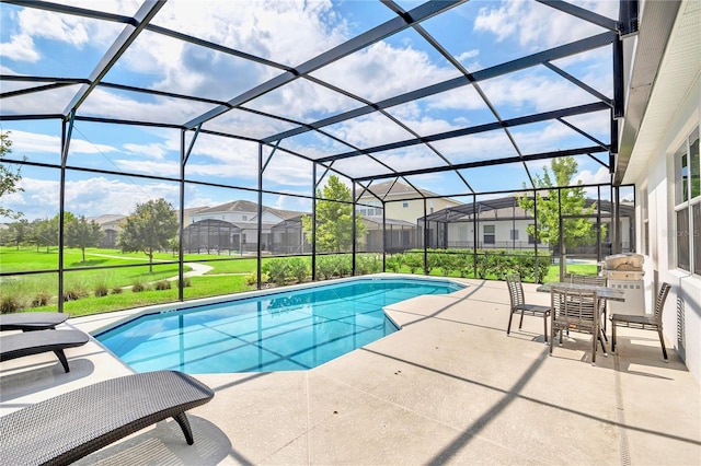 view of swimming pool with a lawn, a patio area, and a lanai