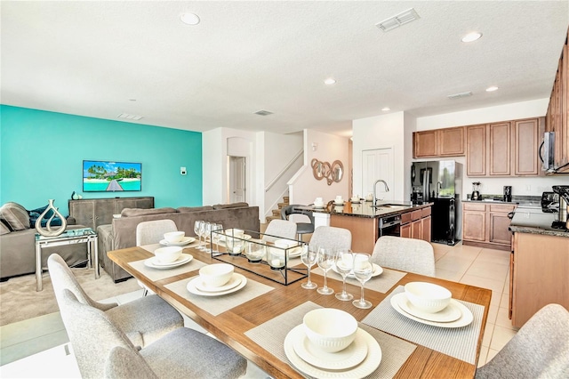 dining room with light tile floors and sink