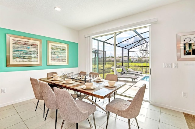 tiled dining room with a textured ceiling