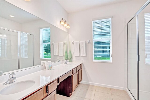 bathroom featuring walk in shower, tile flooring, and double vanity