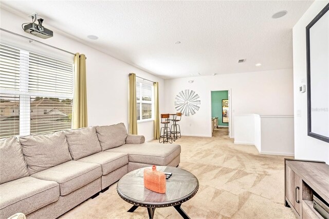 living room with a wealth of natural light and light colored carpet