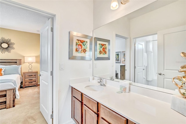 bathroom with a textured ceiling and vanity with extensive cabinet space