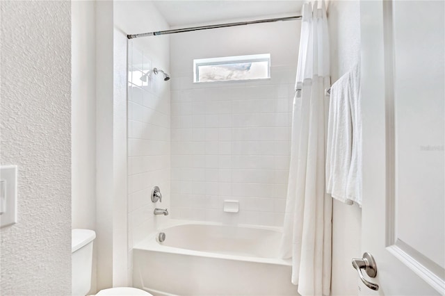 bathroom with toilet and shower / tub combo