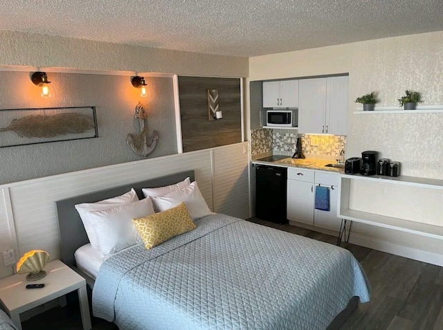 bedroom featuring a textured ceiling, sink, and dark wood-type flooring