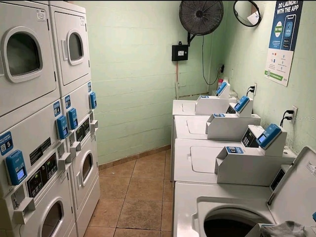 laundry room featuring stacked washer / drying machine, washing machine and dryer, and light tile floors