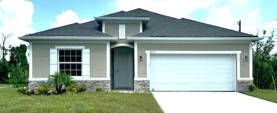 view of front of home with a garage and a front yard