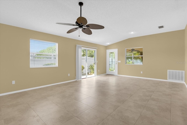 tiled spare room with vaulted ceiling and ceiling fan