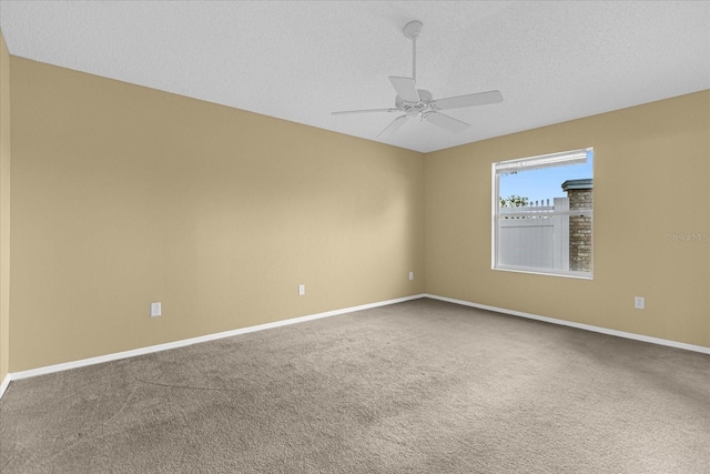 unfurnished room featuring a textured ceiling, ceiling fan, and carpet