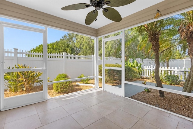 unfurnished sunroom with ceiling fan