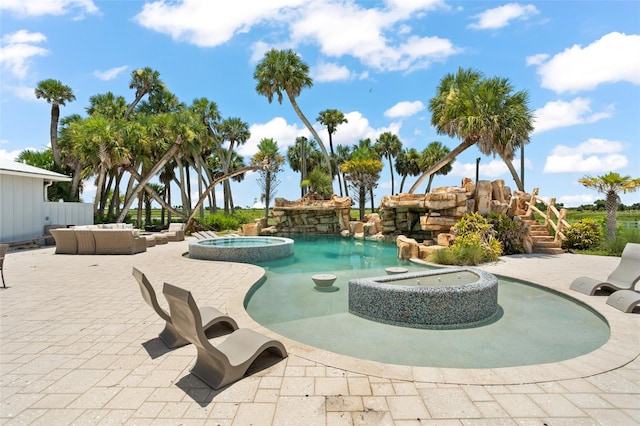 view of pool with an in ground hot tub and a patio area