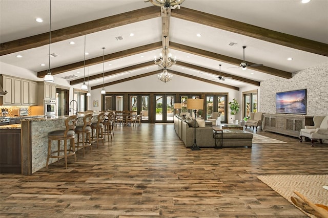 living room with sink, high vaulted ceiling, dark hardwood / wood-style floors, and ceiling fan with notable chandelier