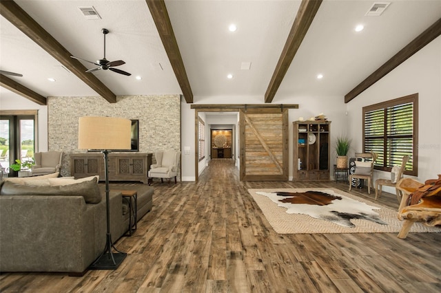 living room with a barn door, ceiling fan, dark hardwood / wood-style floors, and lofted ceiling with beams