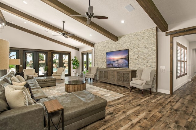 living room with plenty of natural light, dark wood-type flooring, ceiling fan, and lofted ceiling with beams