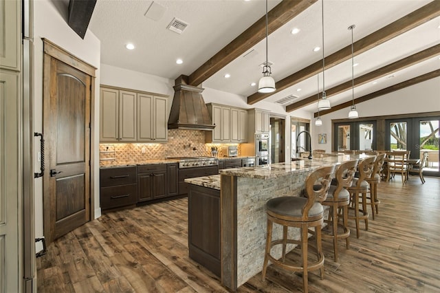 kitchen featuring french doors, dark hardwood / wood-style flooring, decorative light fixtures, and custom exhaust hood