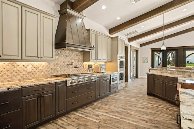 kitchen featuring stainless steel appliances, pendant lighting, custom exhaust hood, and light wood-type flooring