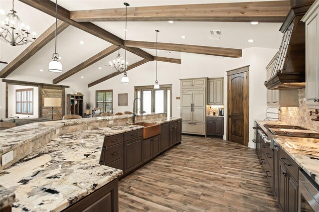 kitchen featuring pendant lighting, sink, and a chandelier