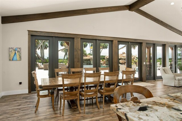 dining space with beam ceiling, french doors, and dark hardwood / wood-style flooring