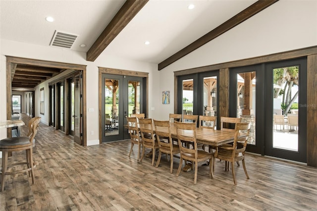 dining space featuring french doors, dark hardwood / wood-style flooring, a healthy amount of sunlight, and vaulted ceiling with beams