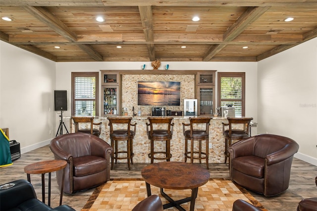 living room with a healthy amount of sunlight, light hardwood / wood-style floors, bar area, and wood ceiling