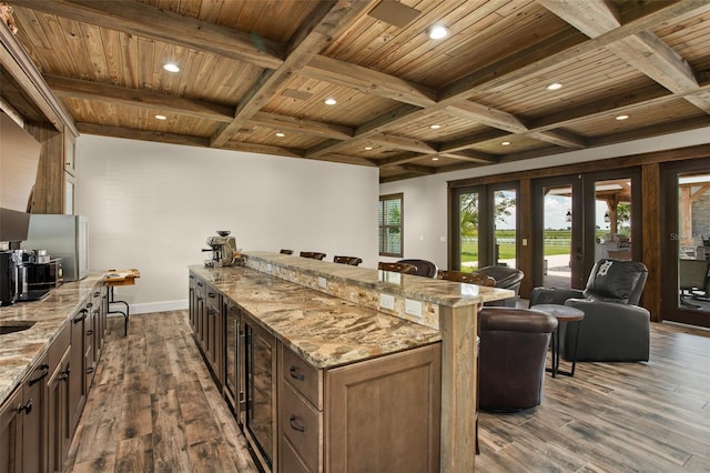 kitchen with french doors, wooden ceiling, light stone countertops, and dark hardwood / wood-style floors