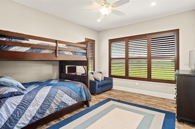 bedroom featuring light hardwood / wood-style floors and ceiling fan