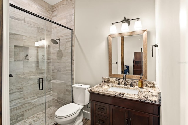 bathroom with a shower with shower door, oversized vanity, and toilet