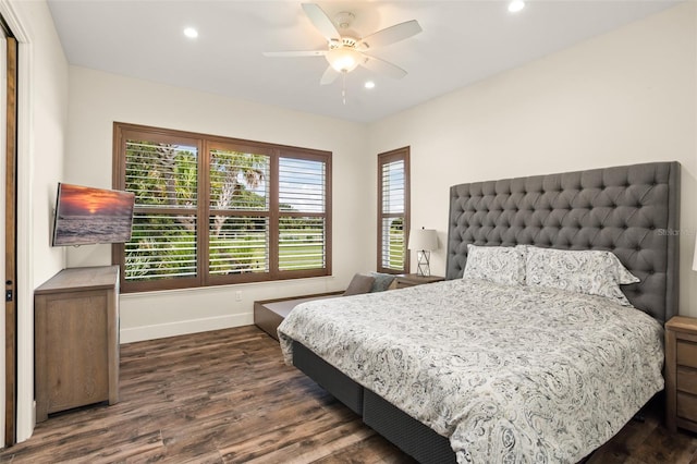 bedroom with dark hardwood / wood-style floors and ceiling fan