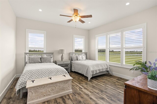 bedroom with ceiling fan and dark wood-type flooring