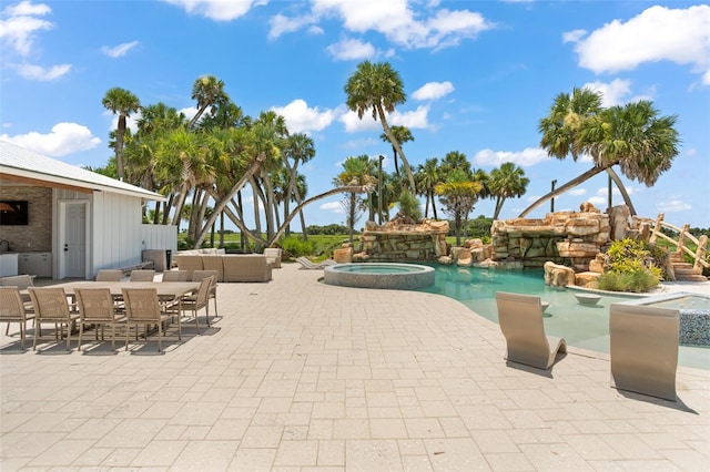 view of swimming pool featuring a patio area and an in ground hot tub