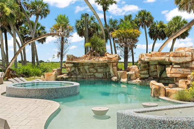 view of swimming pool featuring an in ground hot tub