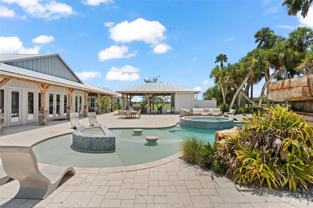 view of pool featuring a gazebo, an in ground hot tub, and a patio