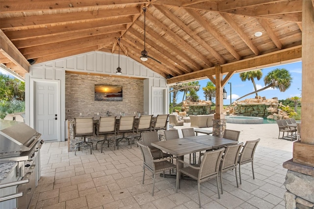 view of patio featuring area for grilling and exterior fireplace