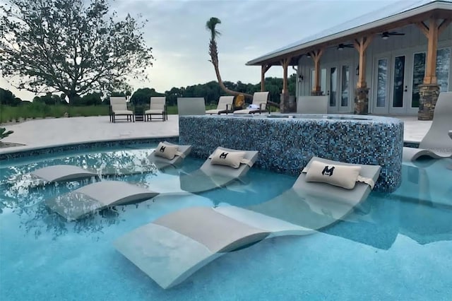 view of pool with a patio area and ceiling fan