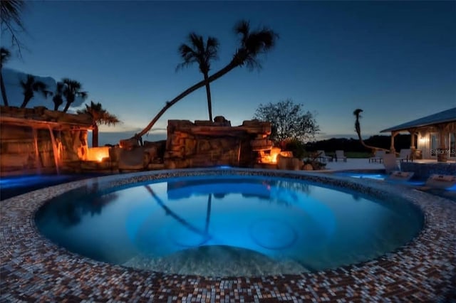 view of pool at dusk