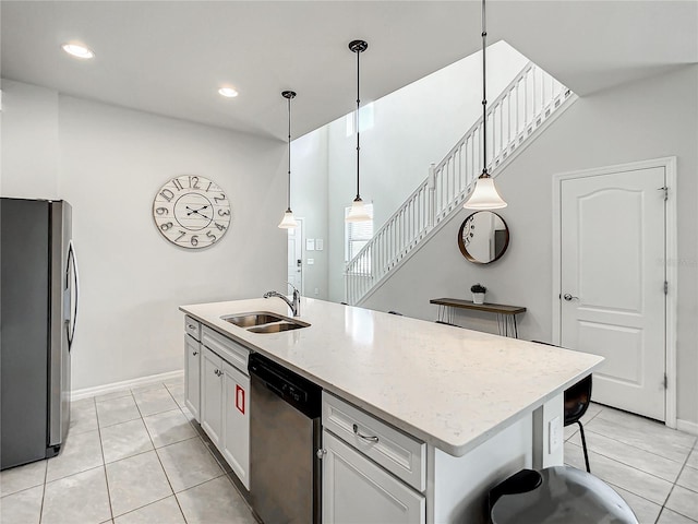 kitchen featuring white cabinets, pendant lighting, sink, and stainless steel appliances