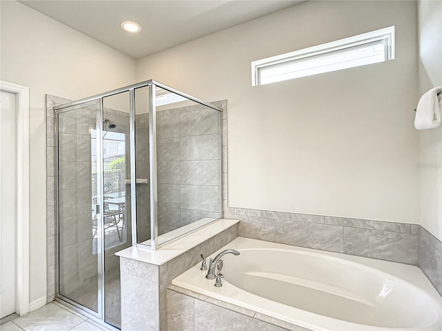 bathroom with tile floors and independent shower and bath