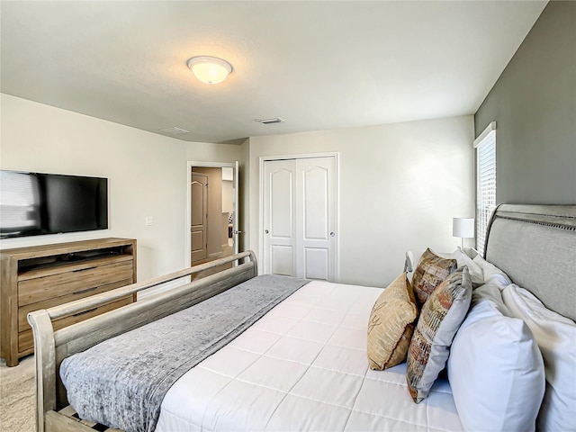 bedroom with a closet and light colored carpet