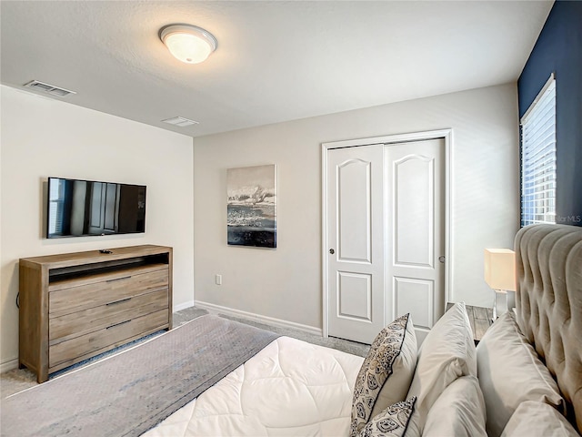 bedroom with light carpet and a closet