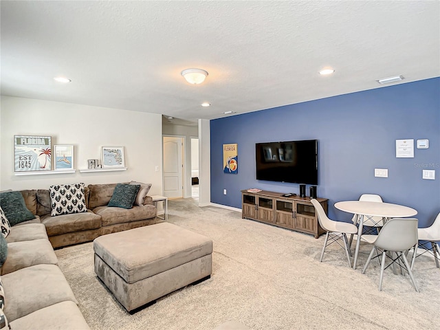 living room with light carpet and a textured ceiling