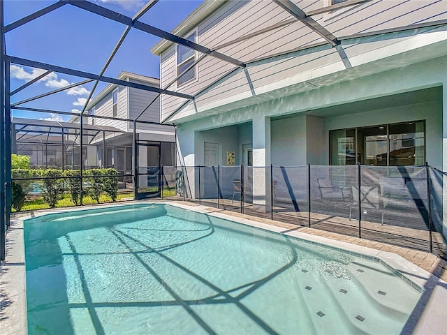 view of swimming pool with a lanai and a patio